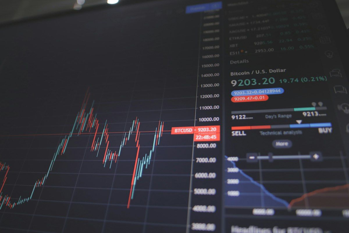 Financial market data displayed across multiple computer monitors in a trading workstation