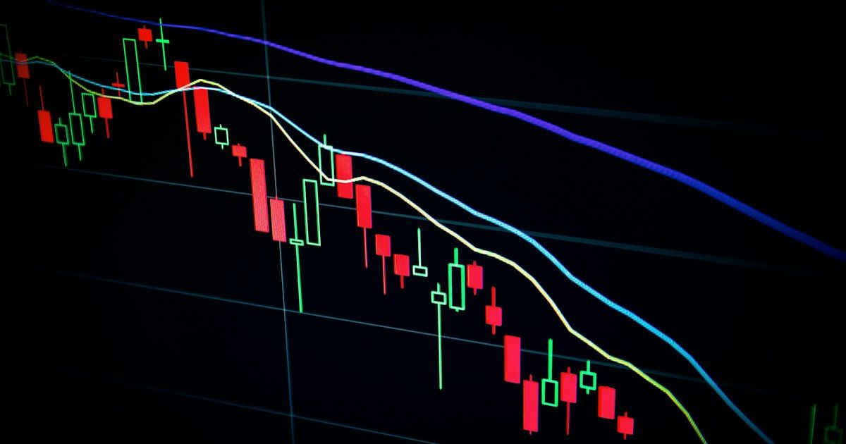 Multiple monitors displaying stock market trading charts in a professional trading environment